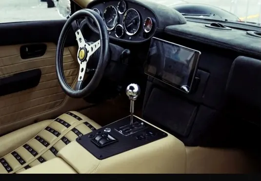 Interior of the development car: tan leather, gated shifter, and centre gauge cluster.