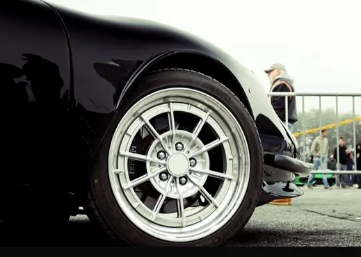 Polished centre-lock style wheel and front fender of the development car.